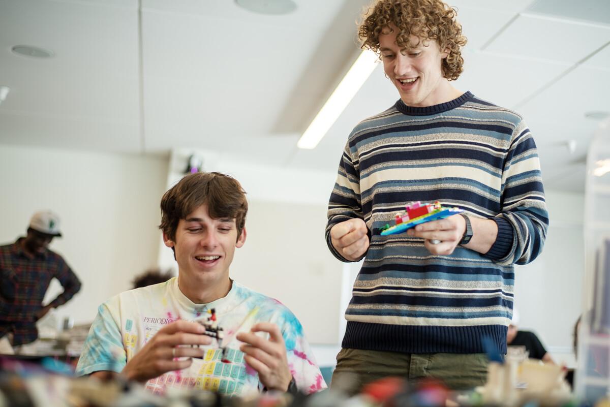 In an event hosted by the Colorado College History Department, Ethan Rothschild '25 (left) and Sam Nystrom-Costales ’25 (right) recreate the lost Ghanaian Asante Palace with historian and graphic novelist Trevor Getz using legos on April 12th, 2023. Photo by Erin Mullins ‘24 / Colorado College